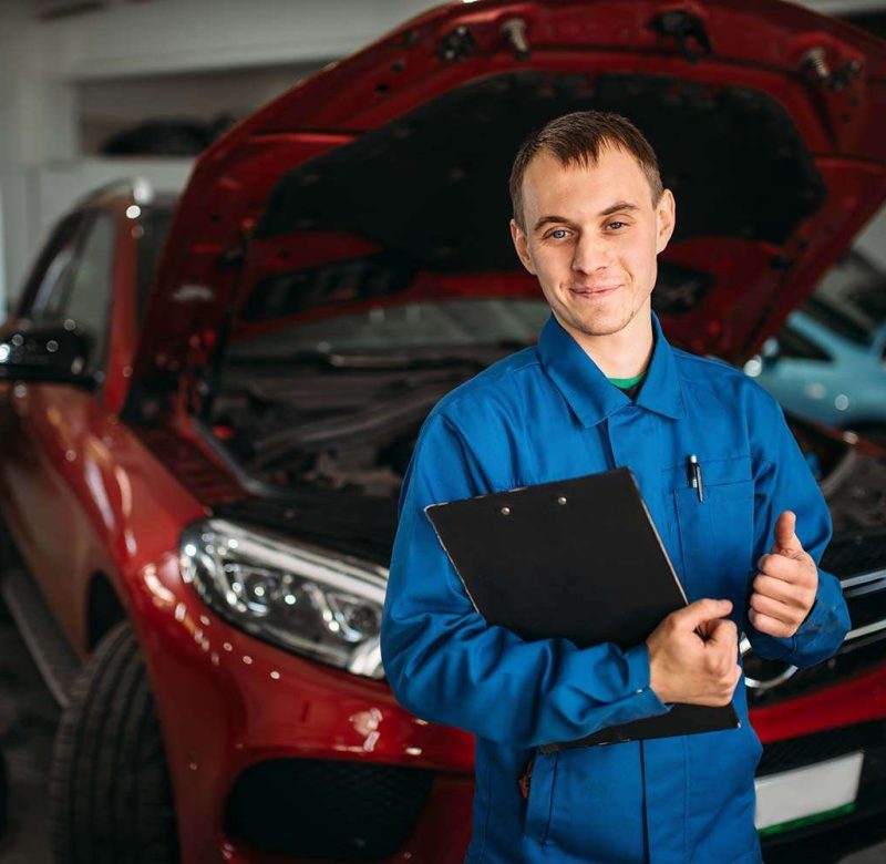technician-with-notebook-car-with-opened-hood-small.jpg